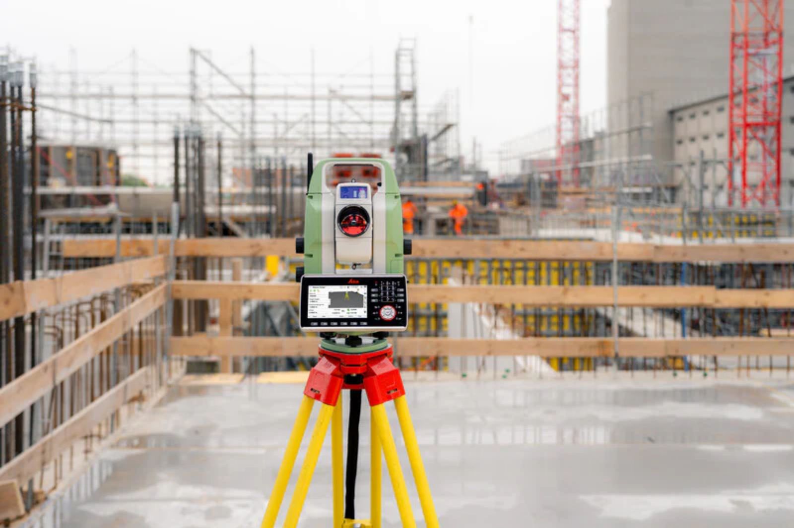 Total station amid structural formwork on a construction site